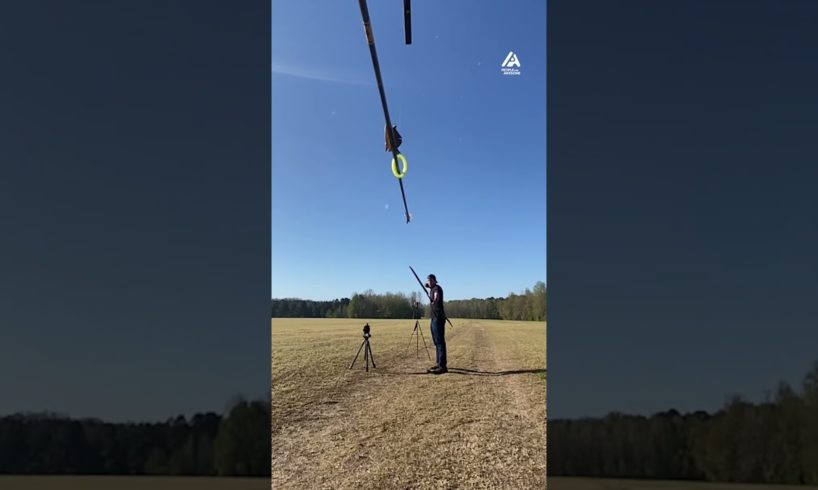 Archer Shoots Arrow Into Horizontally Hanging Pole Through Swinging Ring