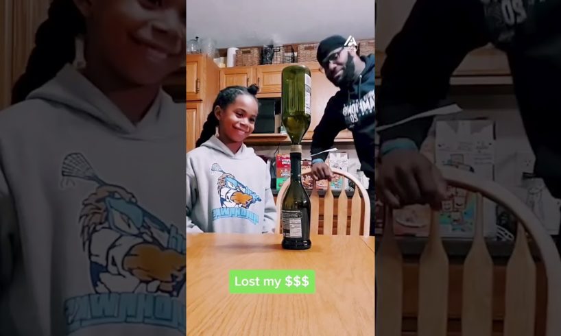 Dad Challenges Daughter to Pull out Note Between Bottles