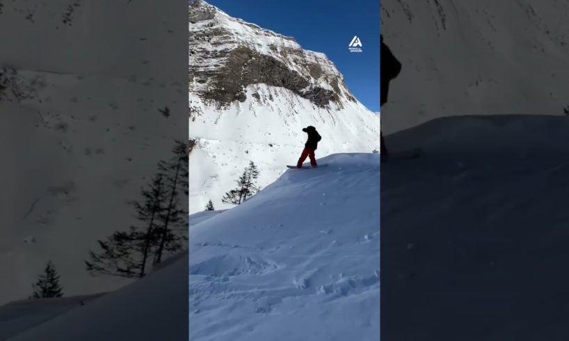 Skateboard Instructor Jumps Off Hill While Snowboarding