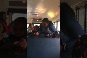 They are fighting on the school bus