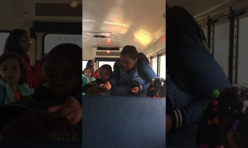 They are fighting on the school bus